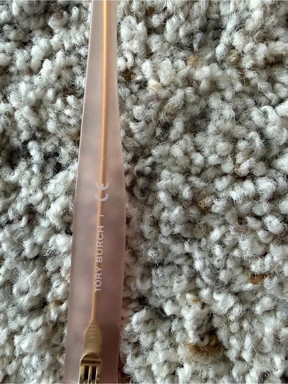 Tory Burch Pale Pink Frame Sunglasses with cat eye shape with gold detail.